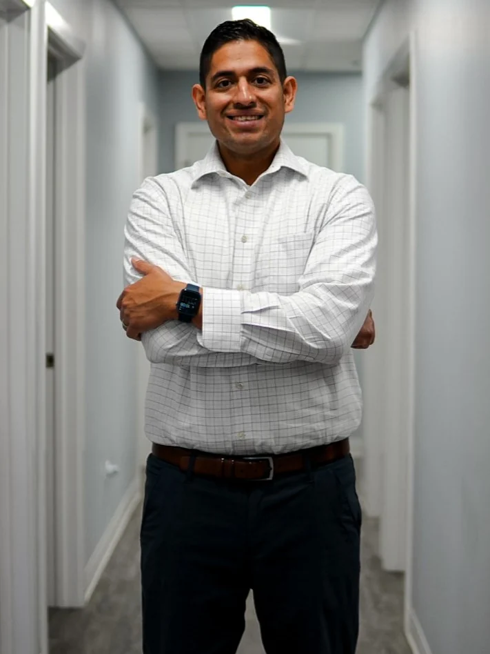 Dr. Hector Martinez, DC standing in the Tri Modern Health office in Hoffman Estates, IL